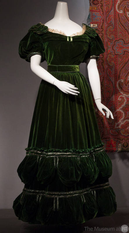 Green velvet floor length dress with short puffed sleeves and off-white lace trim