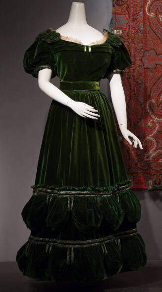 Green velvet floor length dress with short puffed sleeves and off-white lace trim