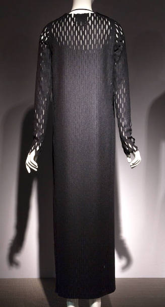 Back view of grey ankle length coat with allover cut slashes