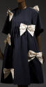 Navy blue knee length tent dress with elbow length bell sleeves, empire waist and large ivory b…