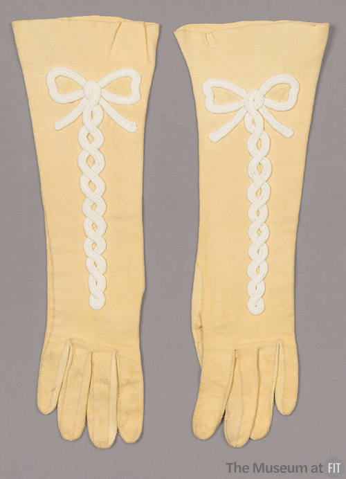 Yellow suede elbow length gloves with white bow center trim 