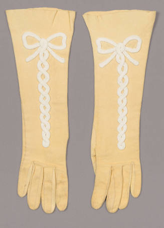 Yellow suede elbow length gloves with white bow center trim 
