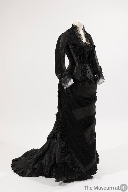 Black two-piece dress, long sleeves, black bead trim on bodice, lace trim on collar and sleeves…