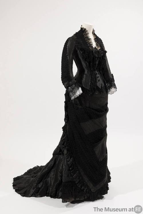 Black two-piece dress, long sleeves, black bead trim on bodice, lace trim on collar and sleeves…