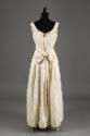 Back view of dress with low round back neckline, zipper back, large bow at waist