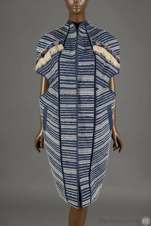 Knee length blue and white striped jacket, cocoon shaped with circular insets on both sides of …