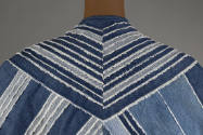Detail view of back shoulders: blue and white strips of denim sewn into V pattern