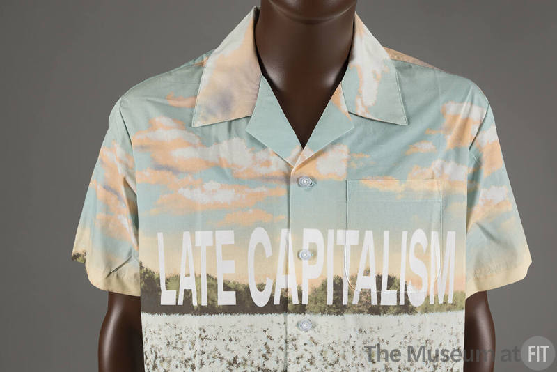 Short sleeve button up shirt with graphic landscape print and text Late Capitalism