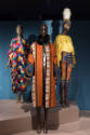 Africa’s Fashion Diaspora exhibition installation view of three dressed mannequins in the “Reac…