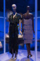 Africa’s Fashion Diaspora exhibition installation view of two mannequins in a black dress and a…
