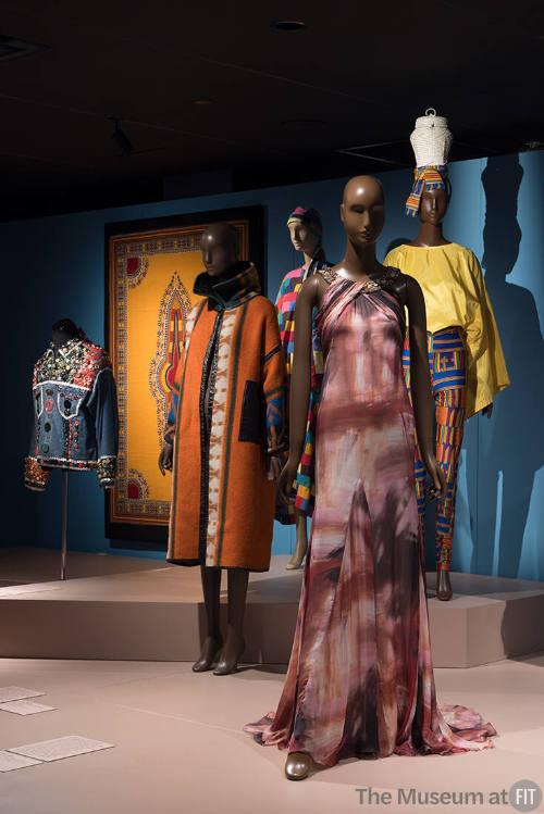 Africa’s Fashion Diaspora exhibition installation view of five dressed mannequins and a textile…