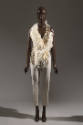 Off-white halter-style top trimmed with feathers and crystals and ivory slim tapered cropped pa…