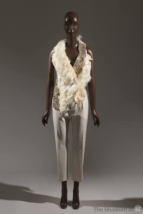 Off-white halter-style top trimmed with feathers and crystals and ivory slim tapered cropped pa…