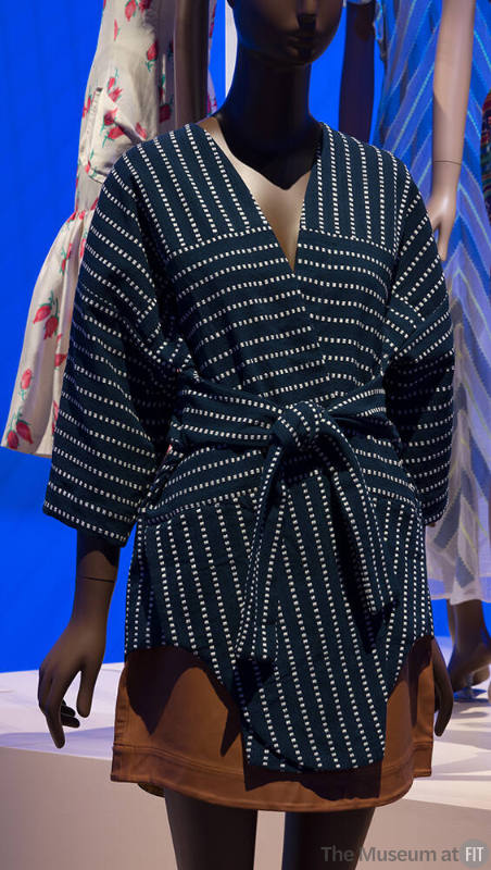 Navy blue short kimono with beige dot stripe pattern and tie belt and tan leather mini skirt