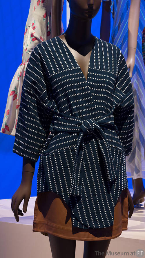 Navy blue short kimono with beige dot stripe pattern and tie belt and tan leather mini skirt