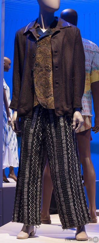 Man’s ensemble of brown button front jacket, top with brown abstract print and brown and white …