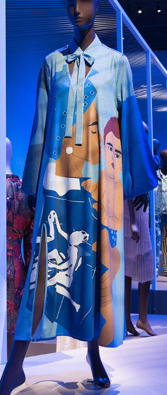 Blue calf length long sleeved tent dress with tie collar, keyhole neck and large scale print of…