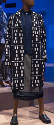Blue knee length button front coat with white geometric print, blue vest and wrap skirt with bl…
