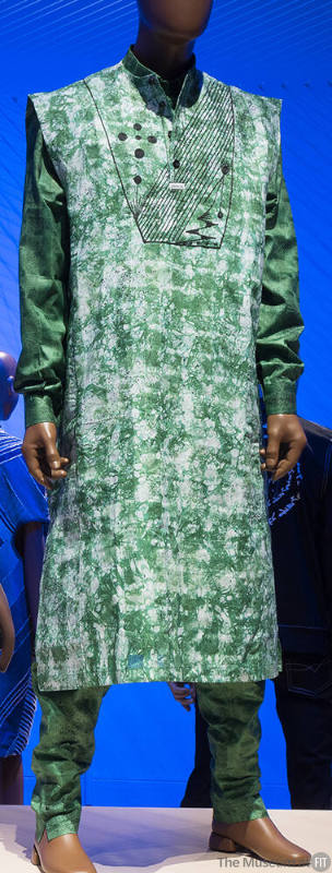 Man’s green and white sleeveless knee length tunic with black geometric embroidery at bib, gree…