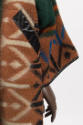 Detail view of orange, white, black and blue geometric designs and black leather trim on sleeve…