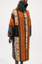 Coat shown worn on reverse side with vertical white, orange, green, blue and black geometric de…