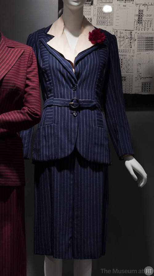 Navy blue and white pinstriped suit with matching belt, knee length straight skirt, white colla…