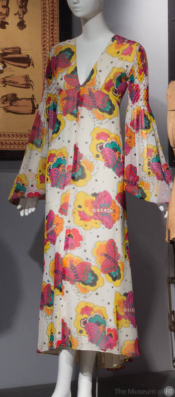 White ankle length dress with cartoon butterfly print in yellow, red, orange, pink and turquois…