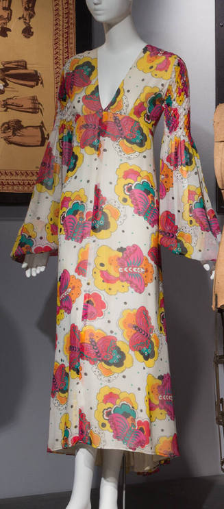 White ankle length dress with cartoon butterfly print in yellow, red, orange, pink and turquois…