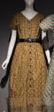 Dark yellow, grey and black paisley printed dress with short sleeves, button front and black be…