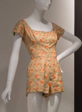 Beige playsuit with orange and black embroidery, cap sleeves and button front