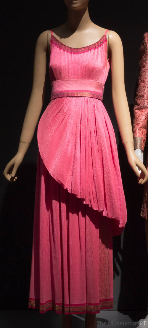 Bright pink floor length evening dress with gold brocade edging, camisole straps and asymmetric…