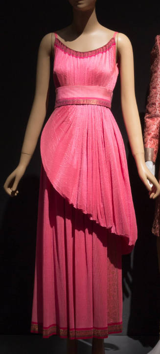Bright pink floor length evening dress with gold brocade edging, camisole straps and asymmetric…