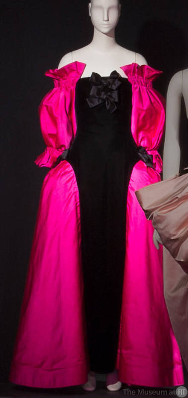 Black floor length evening dress with fuchsia pink off the shoulder sleeves and full side panie…