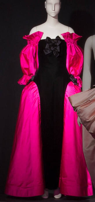 Black floor length evening dress with fuchsia pink off the shoulder sleeves and full side panie…