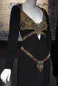Detail view of black evening dress showing multicolor chain mail harness