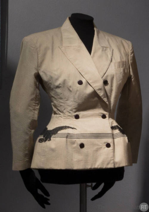 Beige and grey double breasted jacket with black buttons and black horizontal stripes and black…