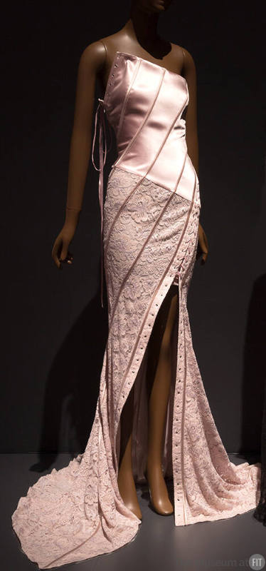 Pink evening dress with strapless asymmetrical corset bodice and lace fish tail skirt with diag…