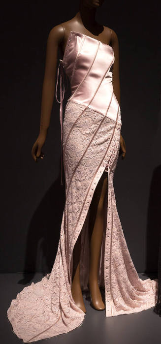 Pink evening dress with strapless asymmetrical corset bodice and lace fish tail skirt with diag…
