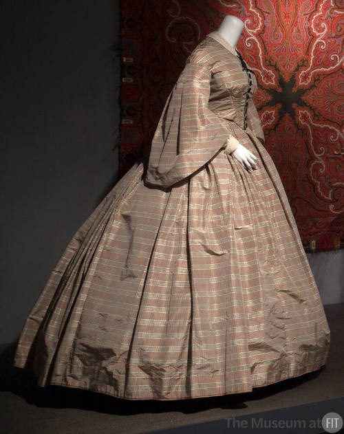Tan, white, and black plaid dress with large bell sleeves, fitted bodice and very large floor l…