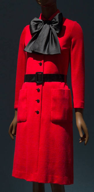 Red knee length shift dress with large black bow scarf, black button front, black belt and fron…
