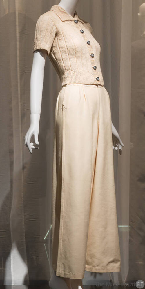 Off-white short sleeve ribknit sweater with silver buttons and matching wide leg pants