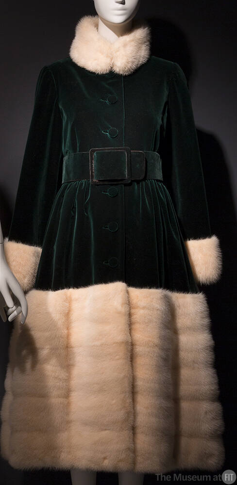 Dark green velvet calf length evening coat with white fur stand collar, cuffs and skirt band fr…