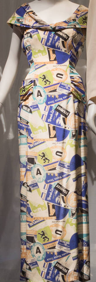 Off-white floor length dress with printed blue, black, ochre and green travel emblems and ticke…
