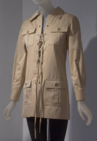 Beige safari jacket with lace up front and button front flap pockets on both sides of chest and…