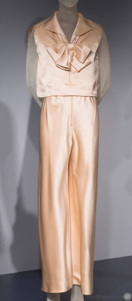 Off-white silk satin evening pantsuit of sleeveless blouse with wide sailor collar and large bo…