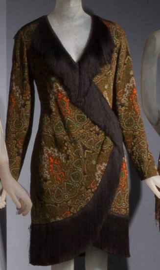 Green, orange, yellow and black paisley print long sleeve tunic with wrap-style front trimmed w…