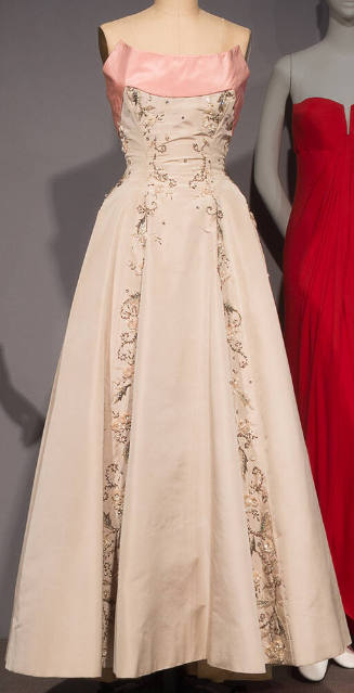 Grey strapless floor length ball gown with pink band at bodice and floral / foliage beading dow…