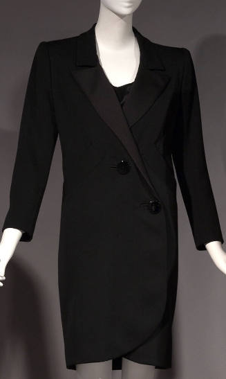 Black tuxedo style coat dress with diagonal two-button closure and above the knee length