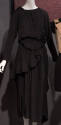 Black long sleeve dress with elasticized pouches asymmetrically draped along skirt, calf length…