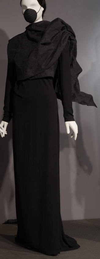 Ensemble of black floor length dress with train, dark grey sleeveless jacket with front wrap pa…